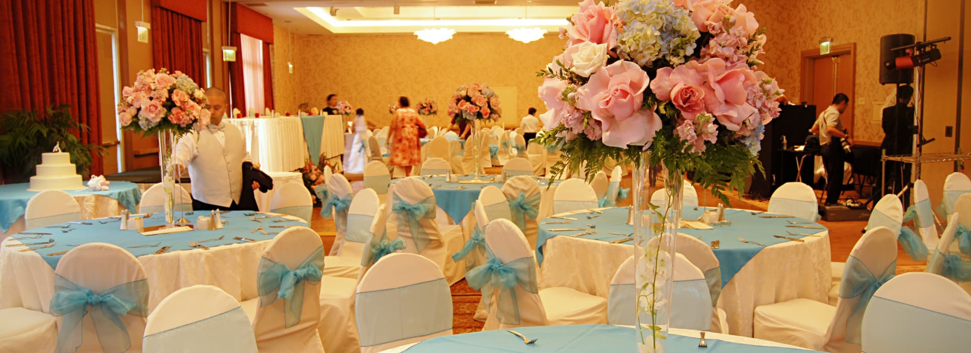 reception area with blue table cloth and different kinds of flowers
