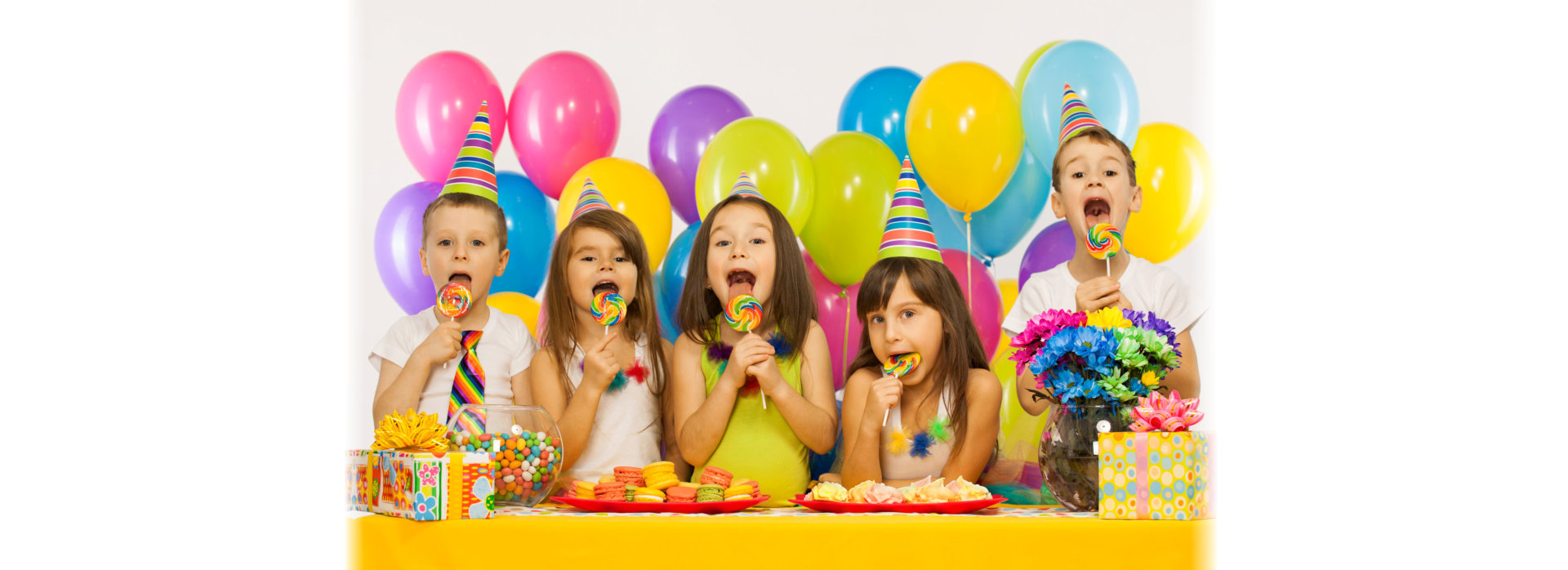 Group of joyful little kids having fun at birthday party.