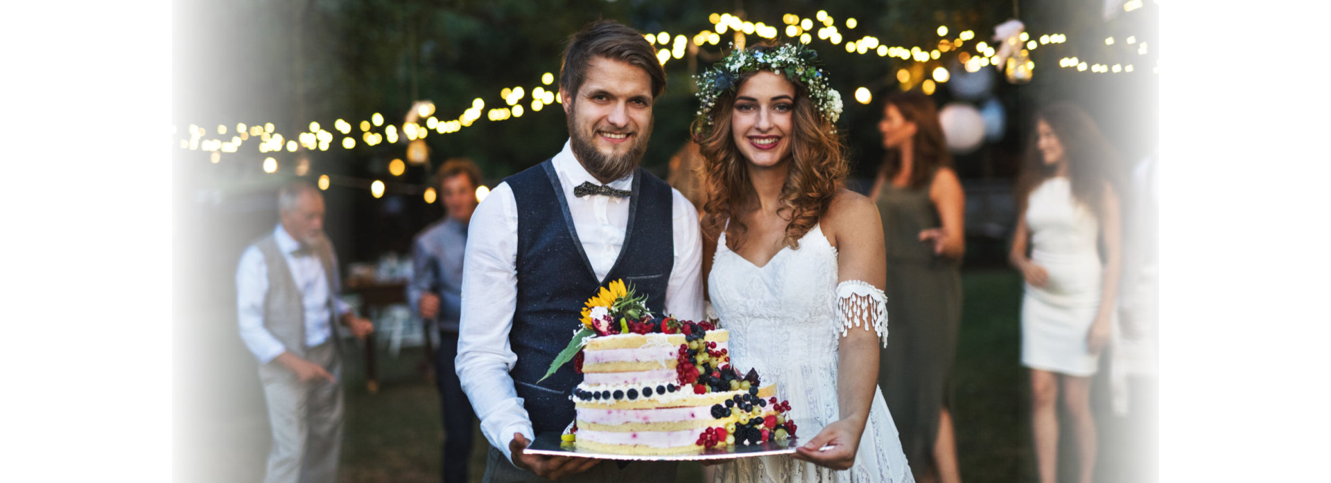 Bride and groom holding a cake at wedding reception
