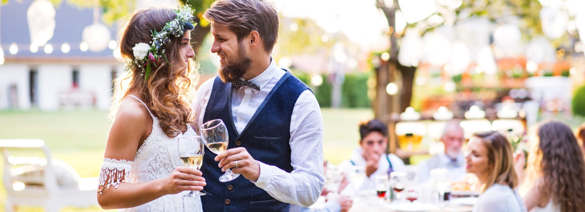 Bride and groom clinking glasses at wedding reception